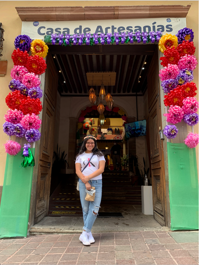 Image of Maria Diaz standing in a colorful doorway